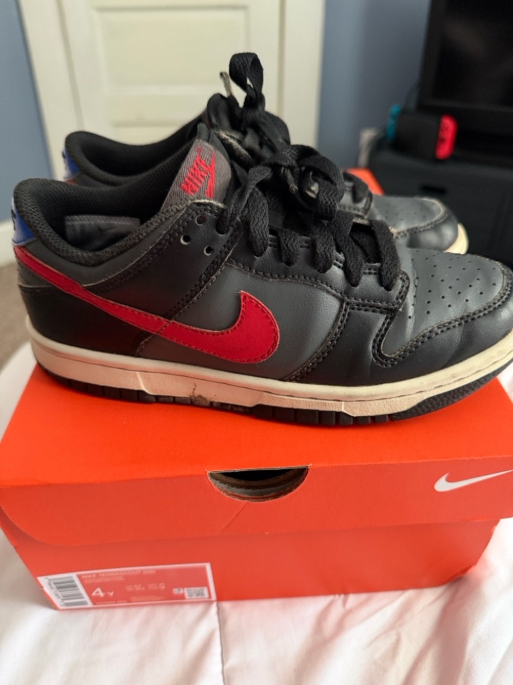 Nike big kid black sneakers with red logo